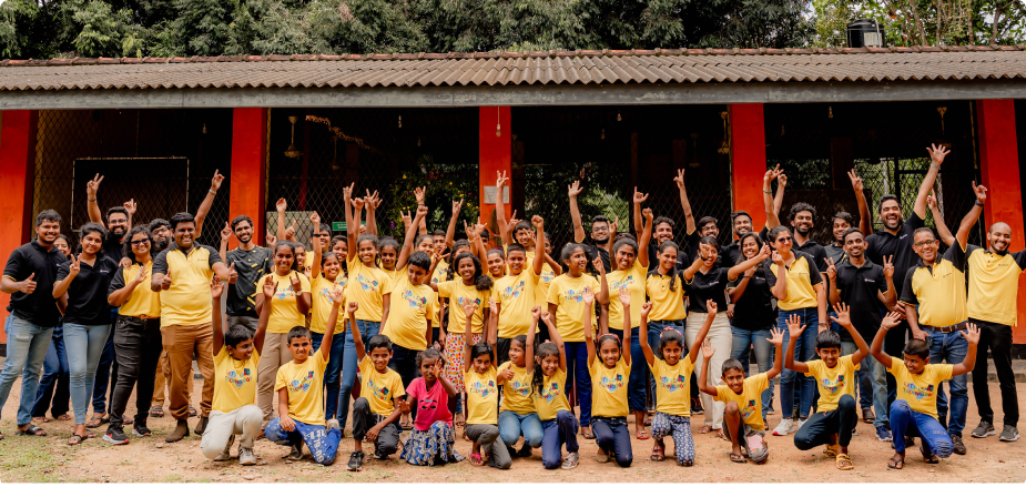 Rootcoders and Students cheering in front of the school building